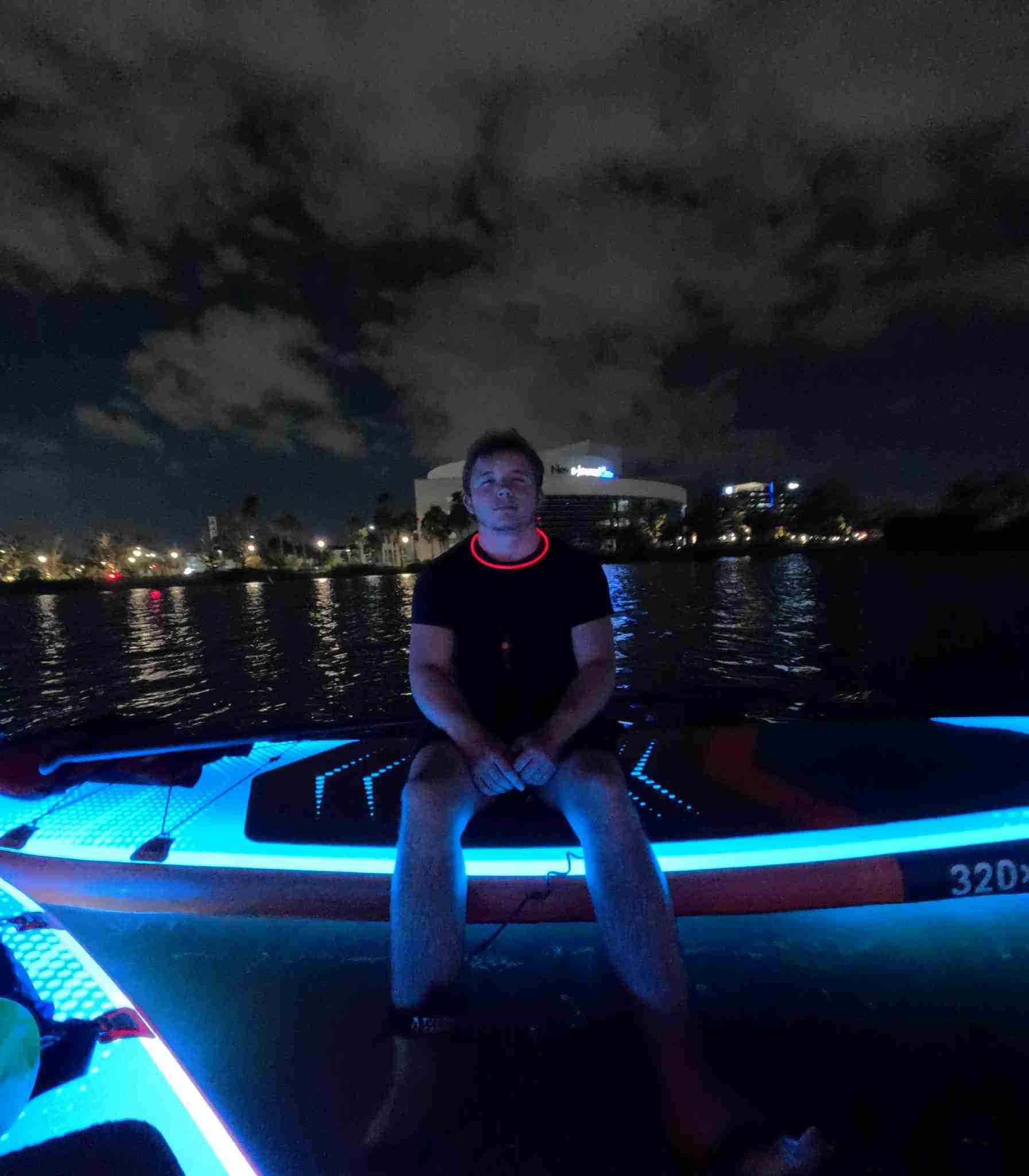 LED glow paddleboard tour at night in Daytona Beach with Pirate Bay Paddle, showing illuminated boards on the Halifax River.